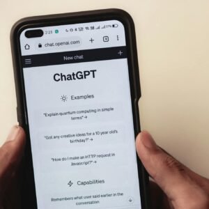 Webpage of ChatGPT, a prototype AI chatbot, is seen on the website of OpenAI, on a smartphone. Examples, capabilities, and limitations are shown.